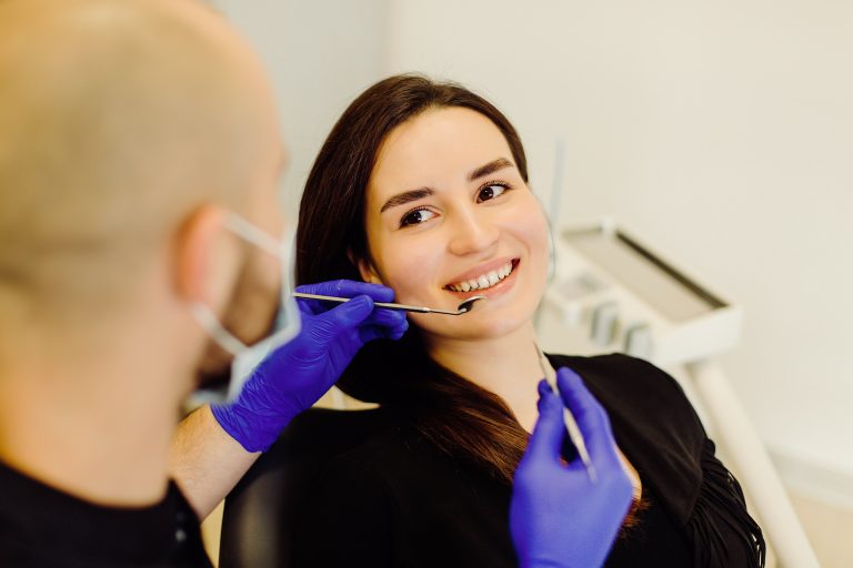 Dentist examining a patient's gums