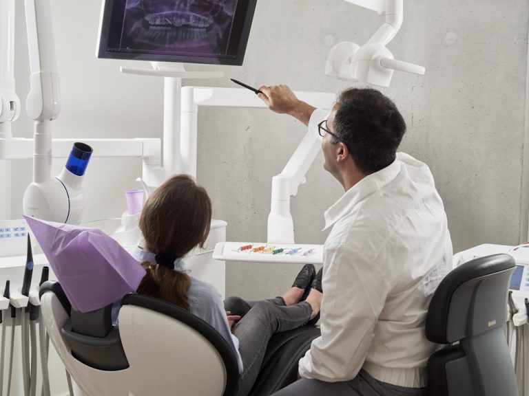 Dentist treating a patient in the surgery